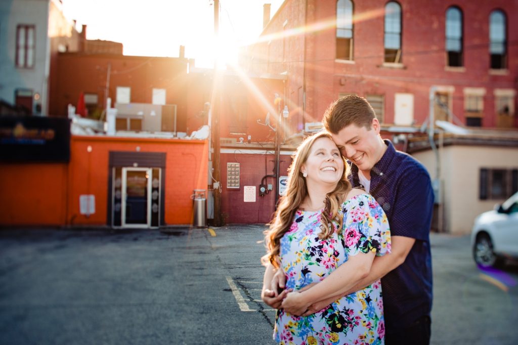 Kyla & Charlie's Delaware Ohio Engagement Photos - downtown Delaware sun coming through buildings and lighting the couple