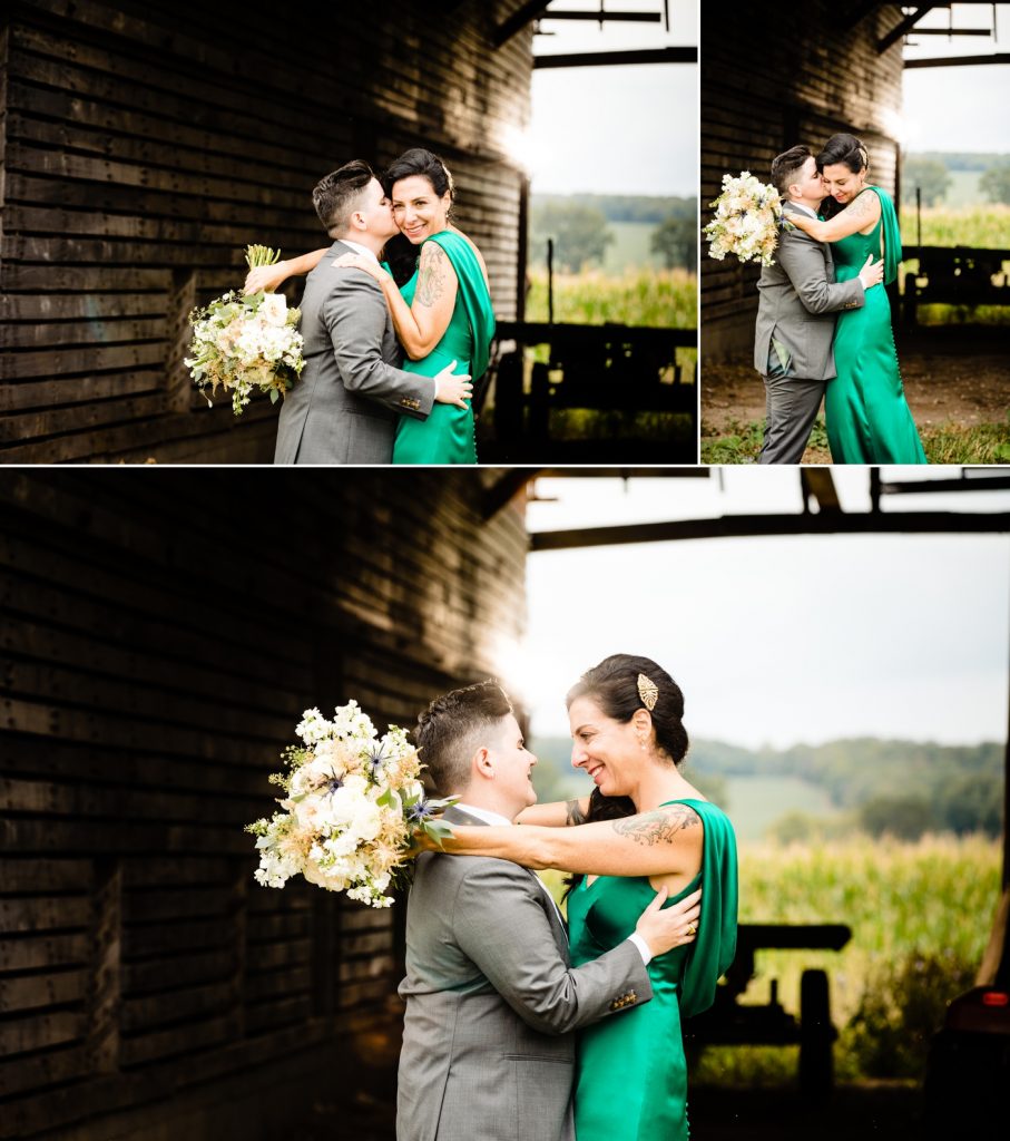 a couple posing in front of a barn before their wedding at Wren Farm