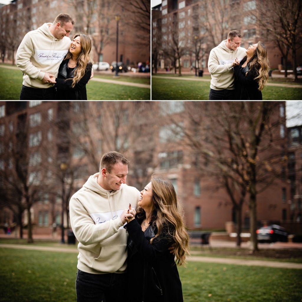 a couple walking and laughing in McFerson Park before their engagement photos at North Market