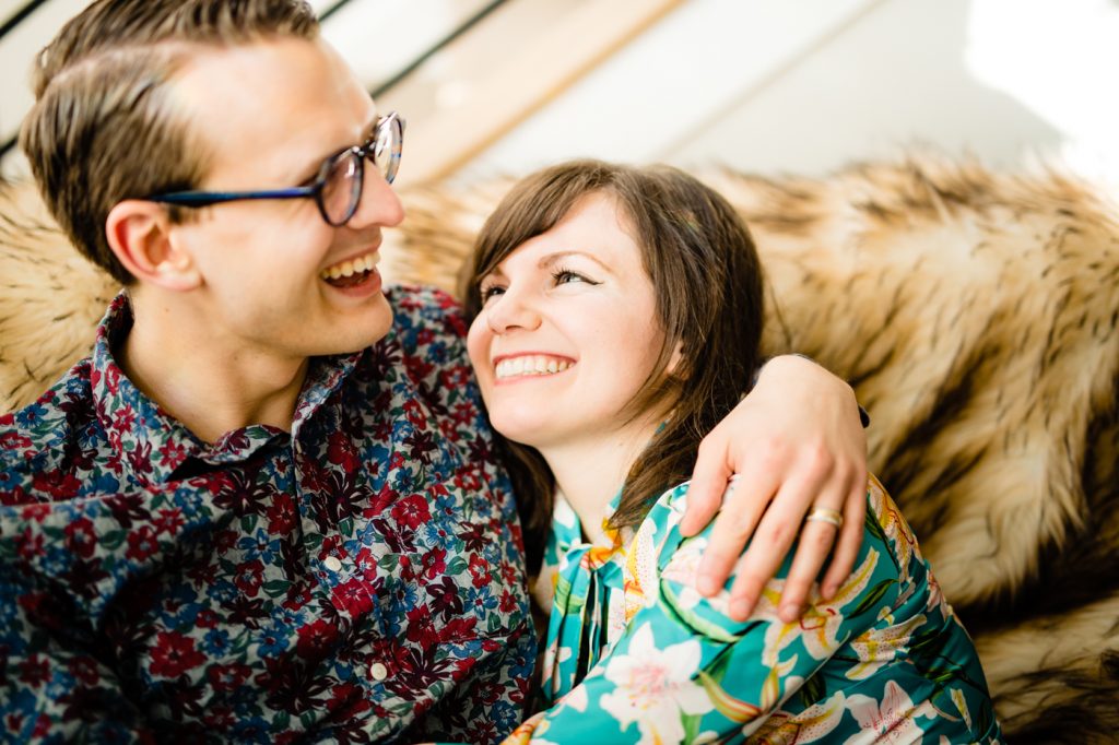 couple laughing during in-home engagement photos