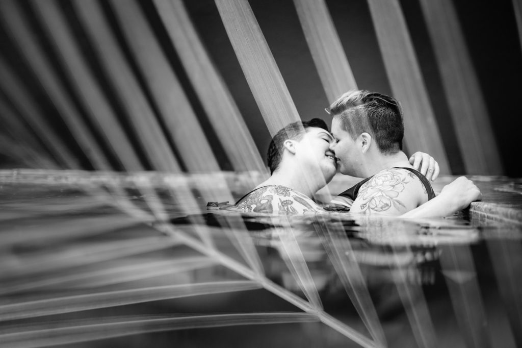 black and white double exposure of a couple kissing and a palm leaf during Puerto Rico photos