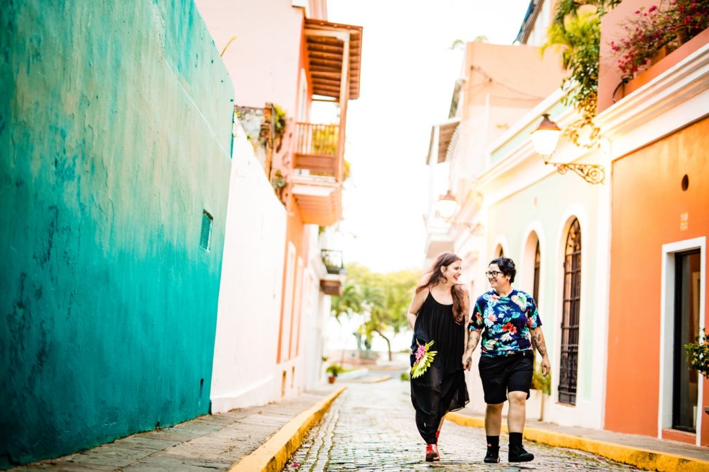 a couple runs through the colorful streets during their San Juan photos