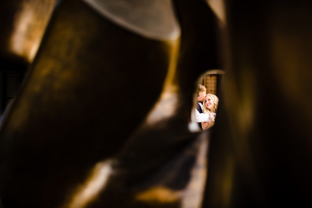 a photo of a couple through a sculpture during engagement photos at The Columbus Museum of Art