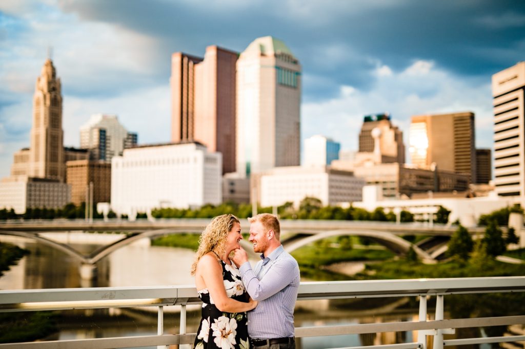 a couple hugs on the Rich Street bridge during their engagement photos at Scioto Mile