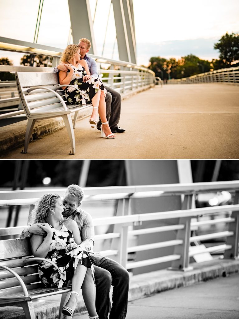 a couple cuddles on a bench while enjoying the view of the Columbus skyline during their engagement photos at Scioto Mile