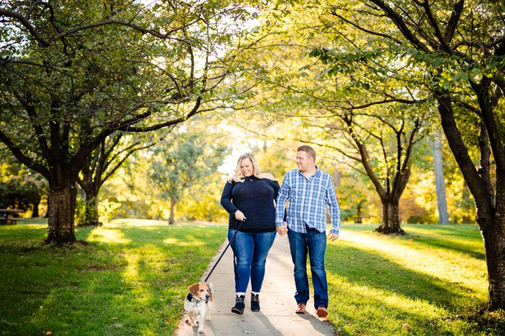 a couple walks their dog during their Goodale Park engagement photos