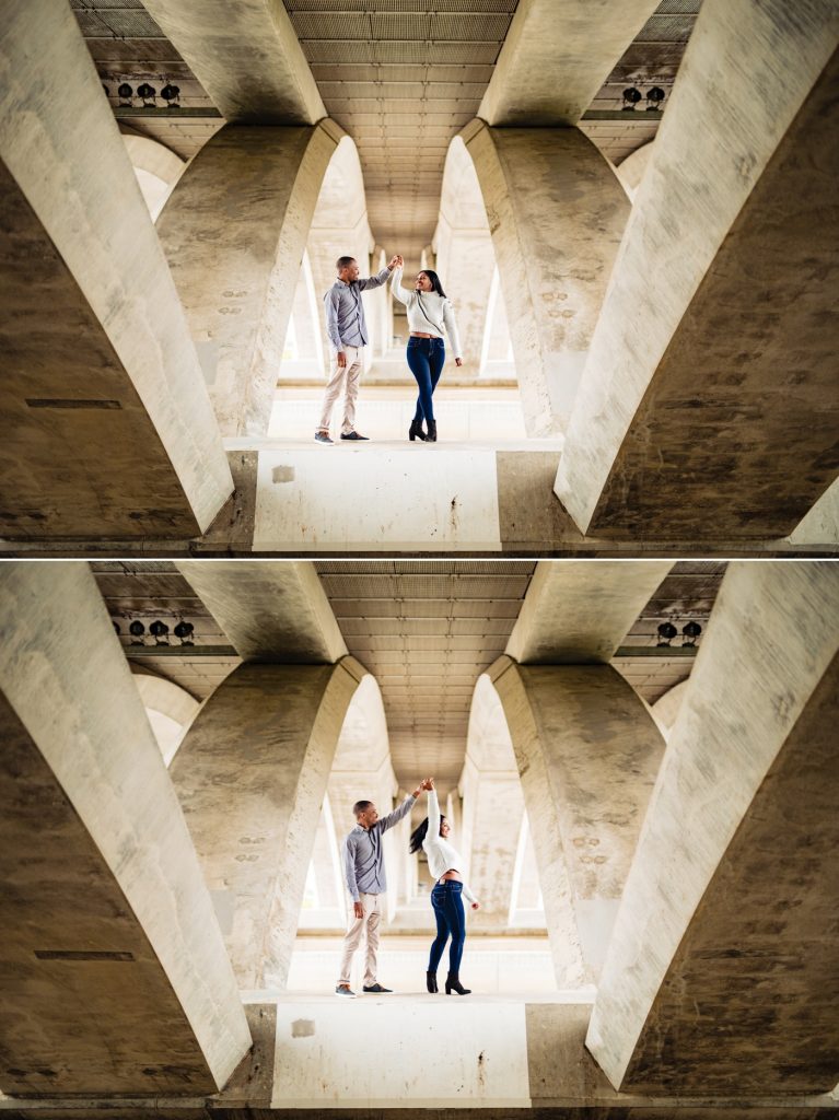 a couple dances beneath the Main Street bridge during their engagement photos at the Scioto Mile
