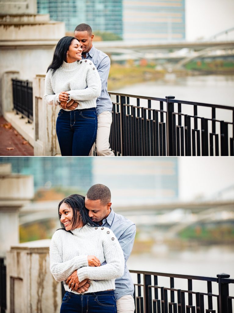 a couple laughs and cuddles during their engagement photos at the Scioto Mile