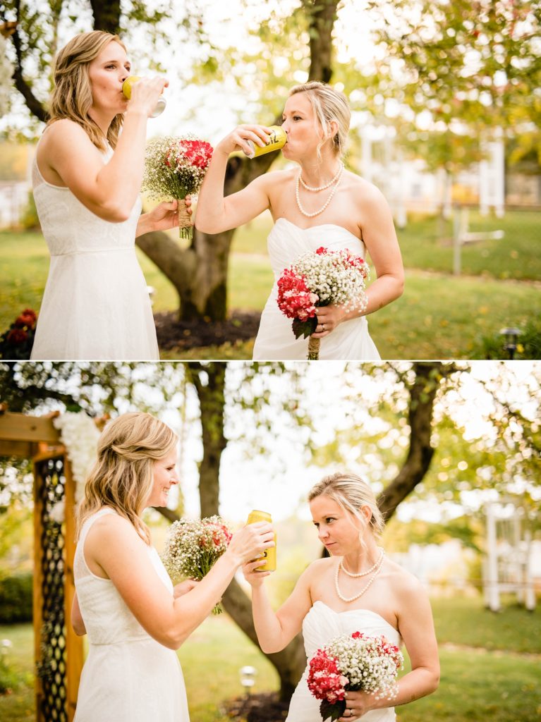 two brides toast with their favorite beer after their intimate backyard wedding ceremony
