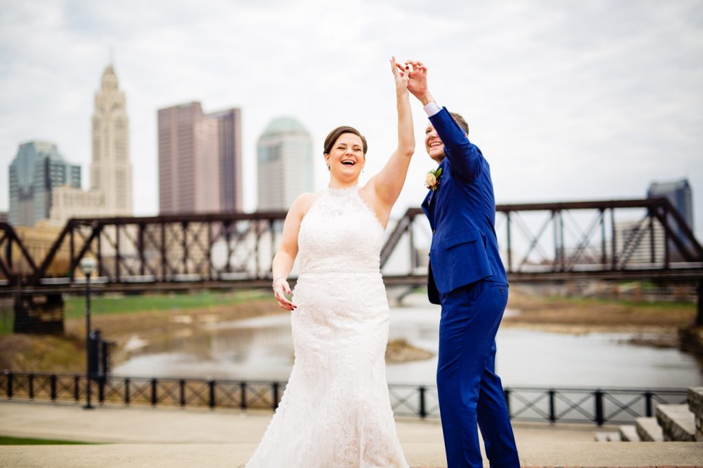 a groom twirls his bride before their wedding at the Columbus Museum of Art