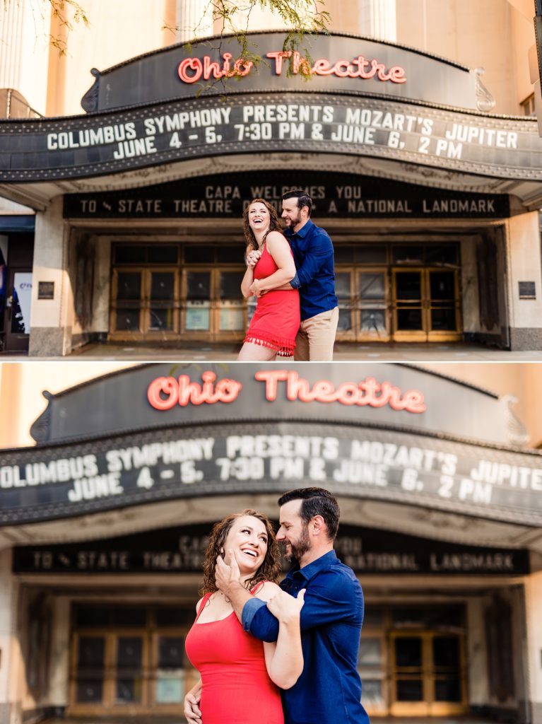 a couple cuddles in front of the Ohio Theater during their engagement photos in downtown Columbus