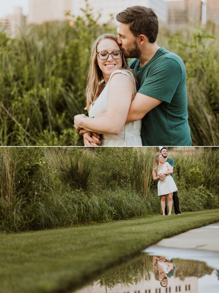 a couple cuddles in the weeds along the Scioto River during their engagement photos at Genoa Park