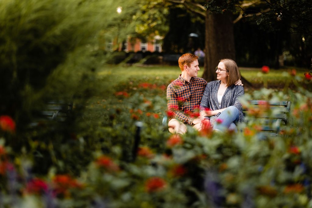 a couple enjoys the beautiful landscaping of Schiller Park during their German Village engagement photos