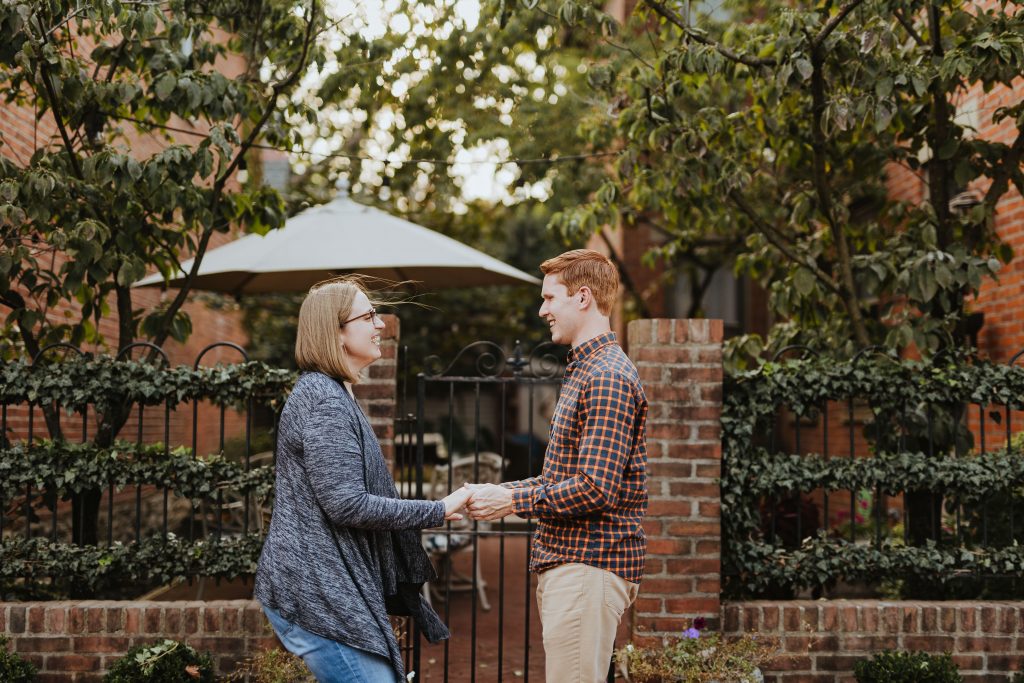a couple laughs and dances during their German Village engagement photos