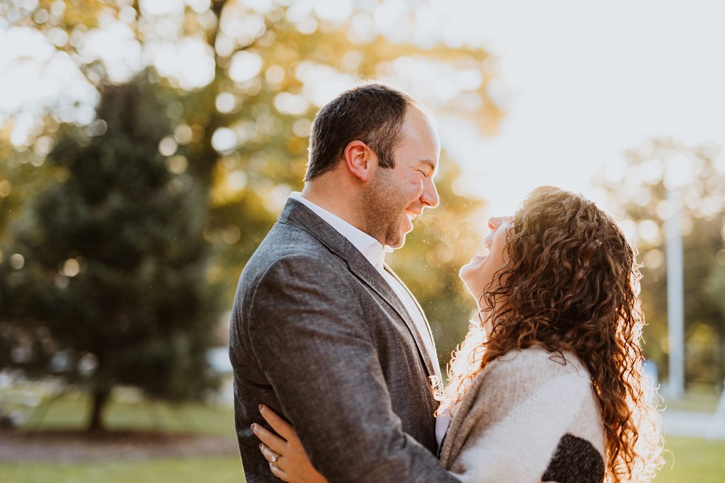 a couple laughs with each other during their engagement photos in Worthington