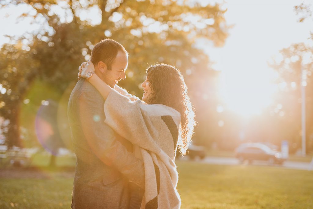a couple enjoys the sunset during their engagement photos in Worthington