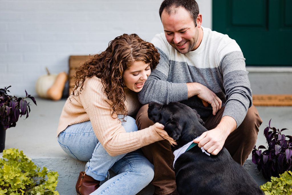 a couple cuddles with their dog engagement photos in Worthington