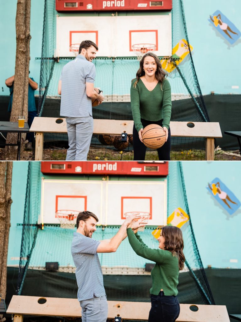 a couple plays pop a shot during their engagement photos at Land Grant Brewing