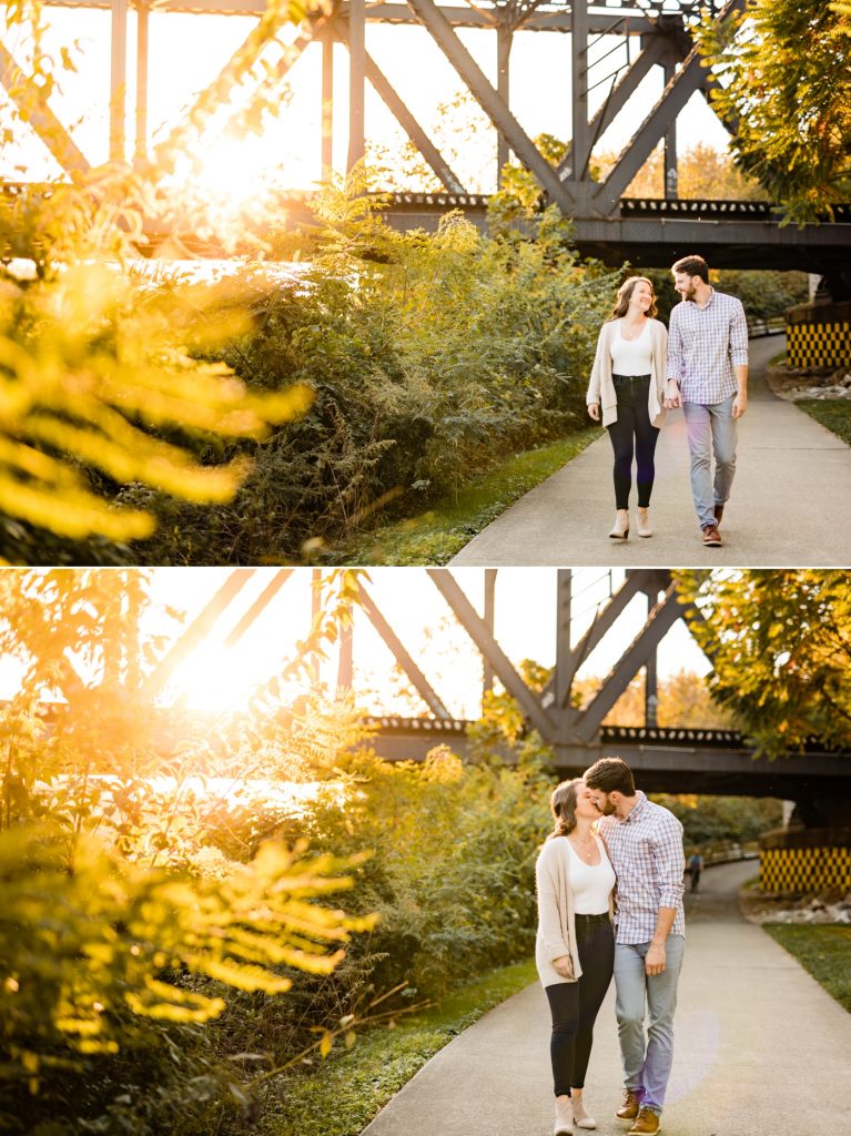 a couple walks along the bike path during their engagement session at North Bank Park