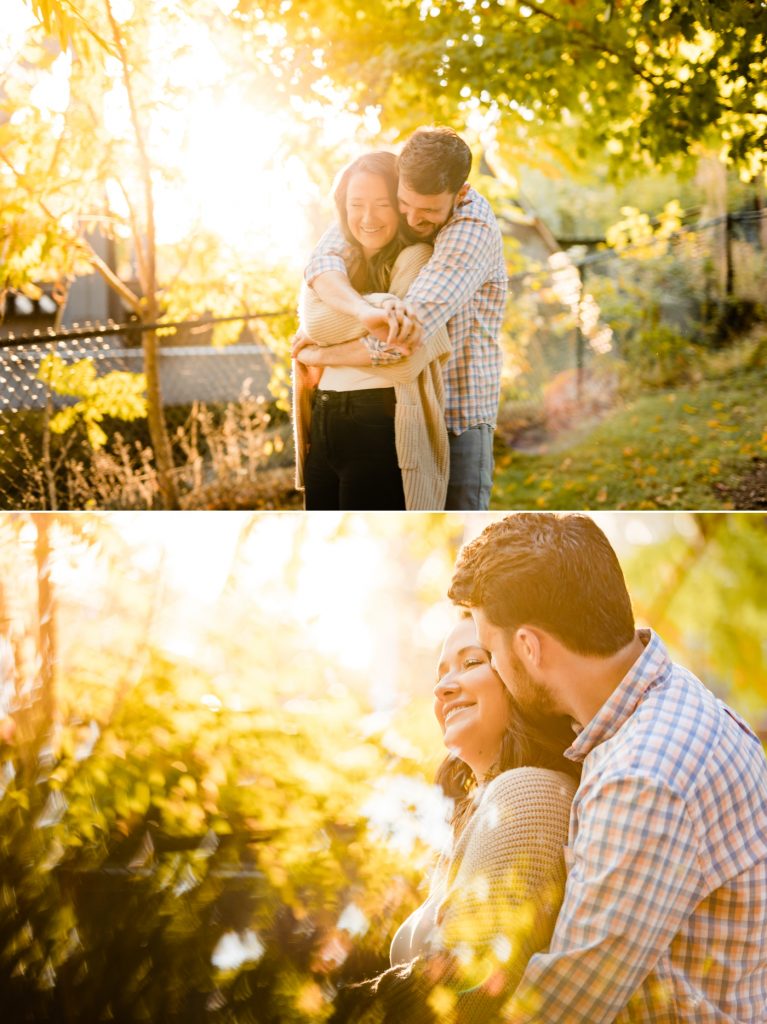 a couple cuddles in front of the sunset during their engagement session at North Bank Park