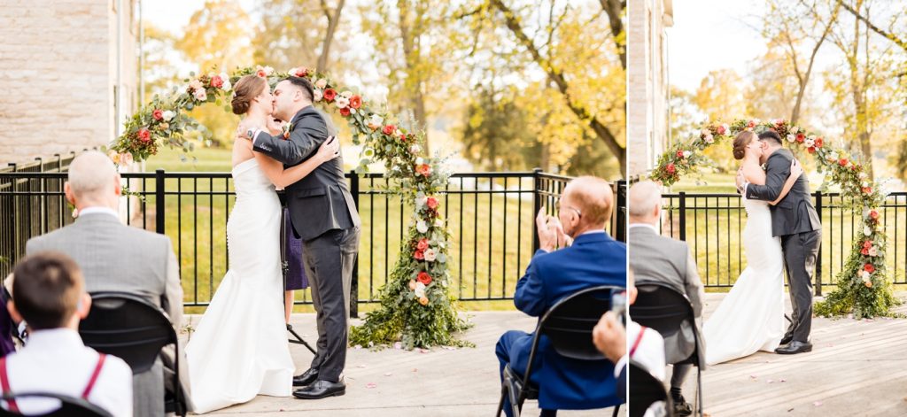 a couple shares their first kiss during their wedding at Lashutka Event Center