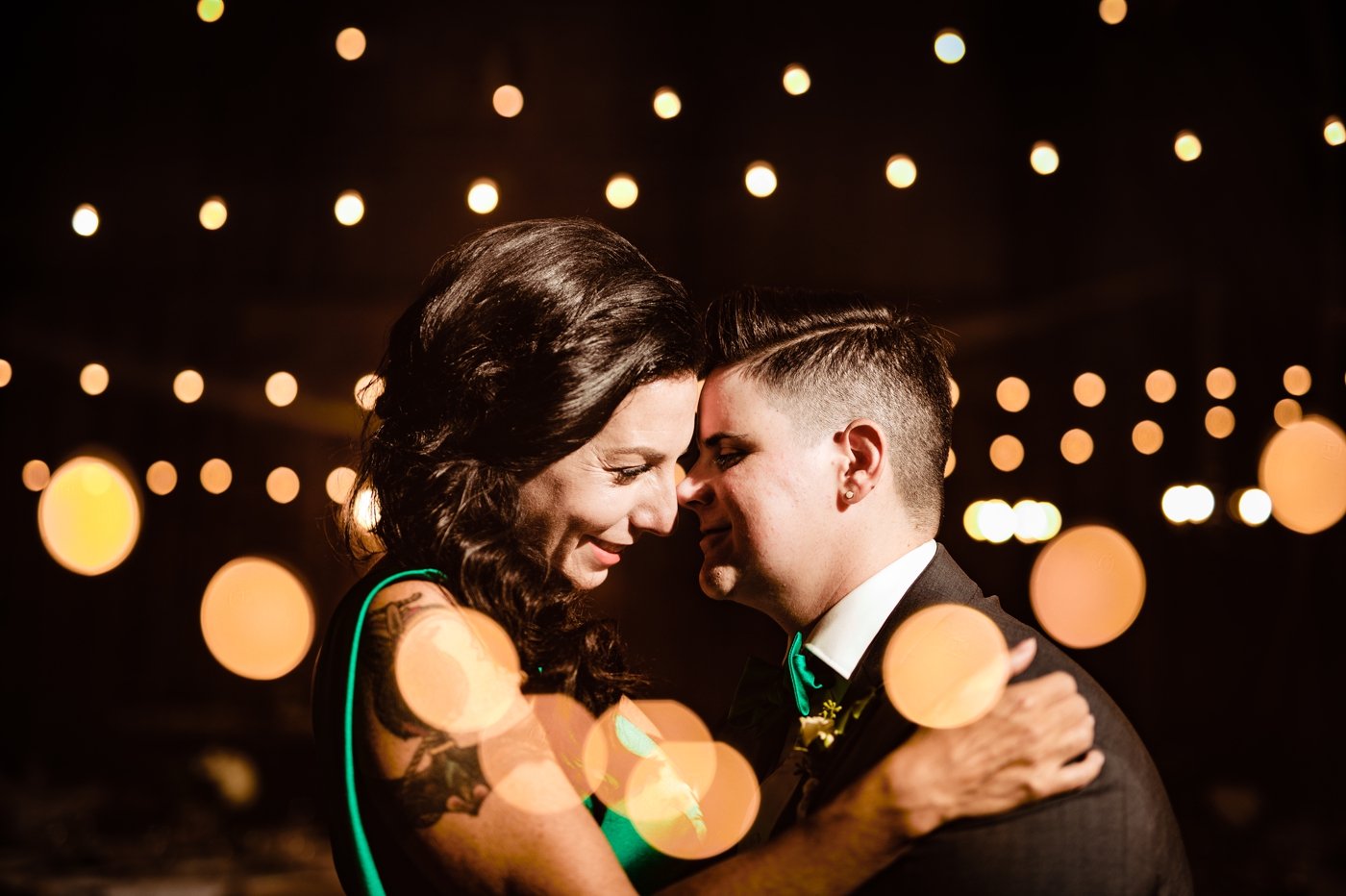 a double exposure of a couple beneath twinkle lights at their wedding at Wren Farm