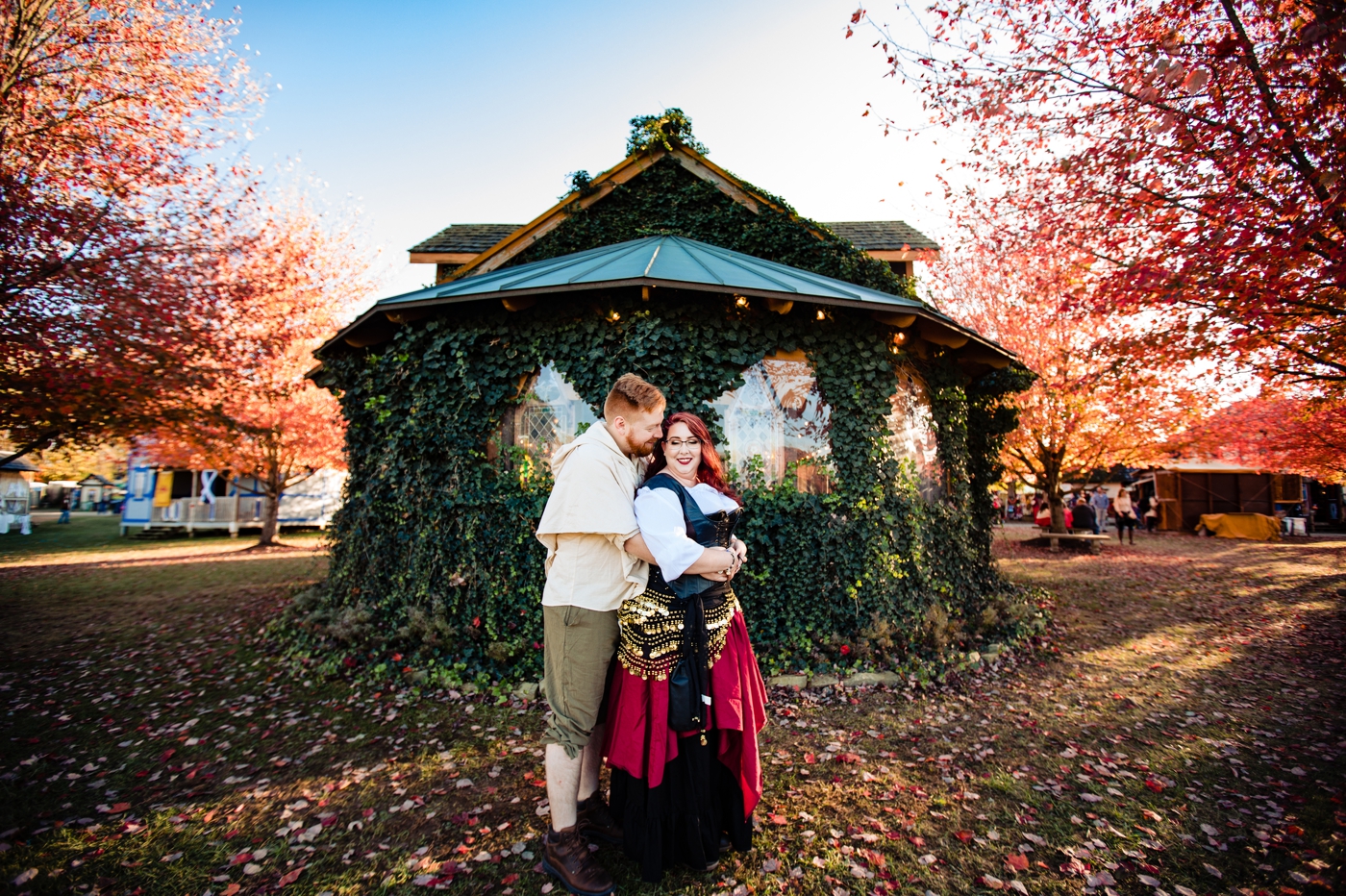 a couple posing in front of the chapel during their engagement photos at the Ohio Renaissance Festival