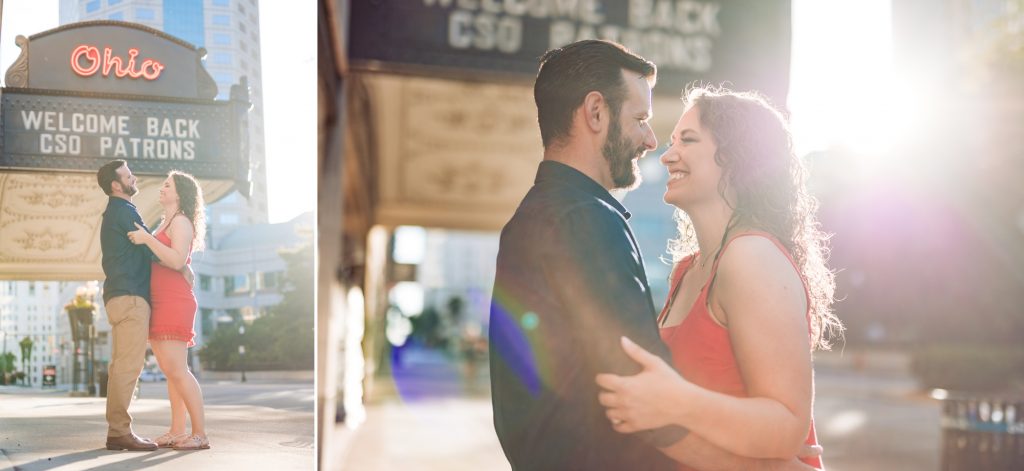 a couple poses in the sunlight during their engagement photos in downtown Columbus