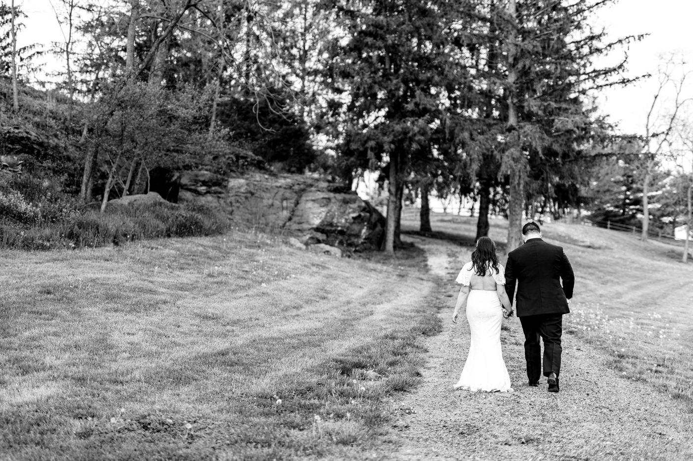 a couple walks back to their wedding at Rockmill Brewery