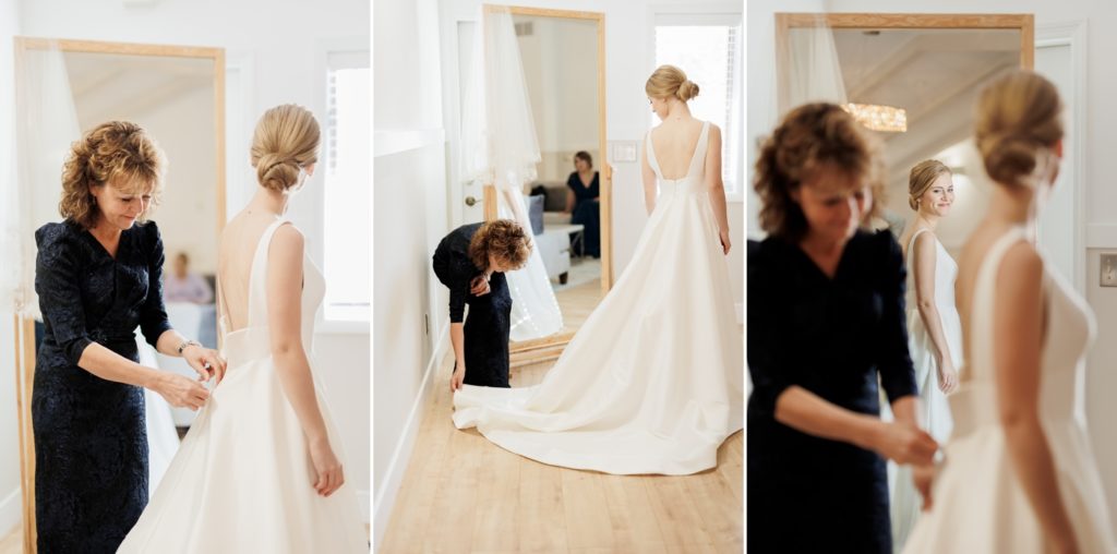 a bride gets dressed with the help of her mom before her wedding at The Brook