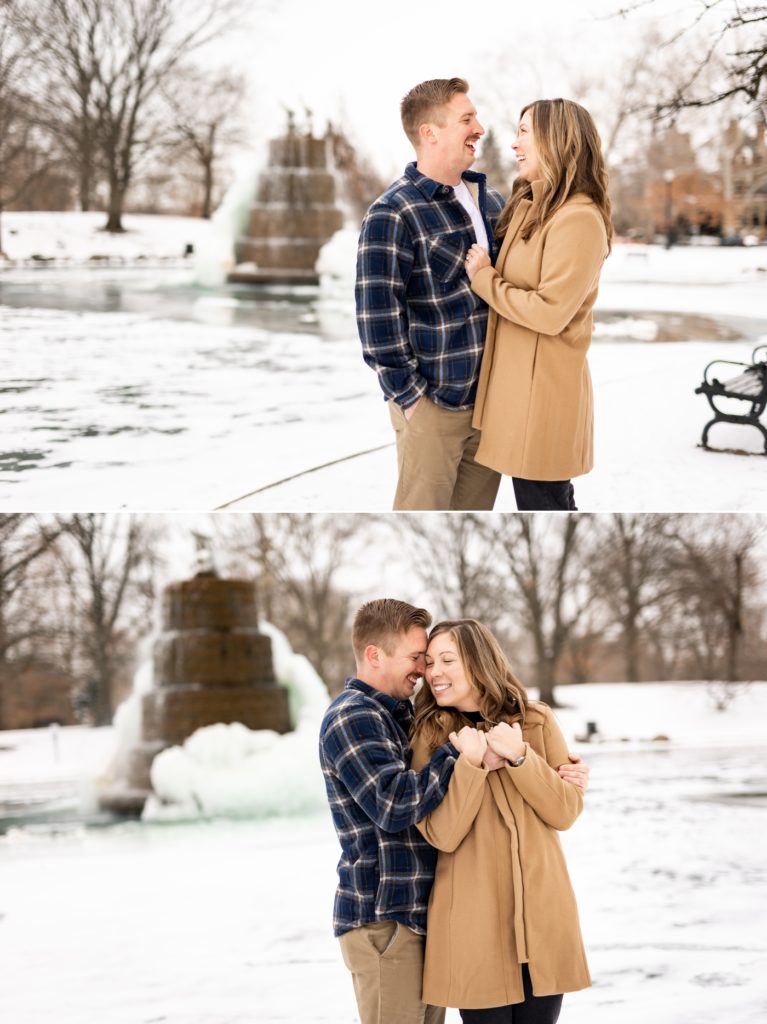 a couple cuddles to stay warm during their snowy Short North engagement photos at Goodale Park